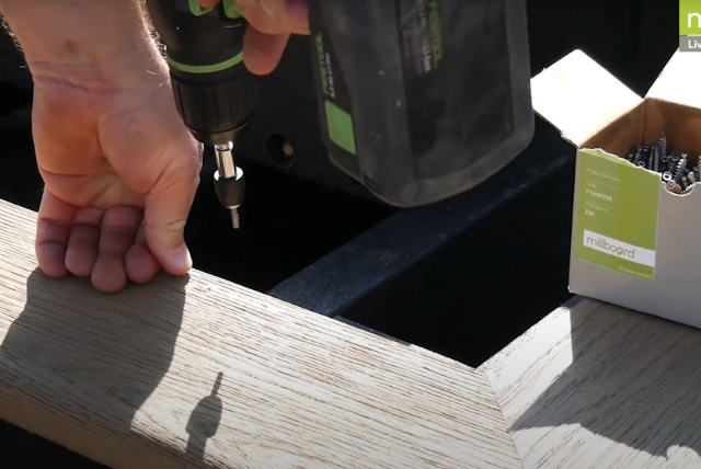 Installing Millboard decking with hidden fixing system using a power drill.