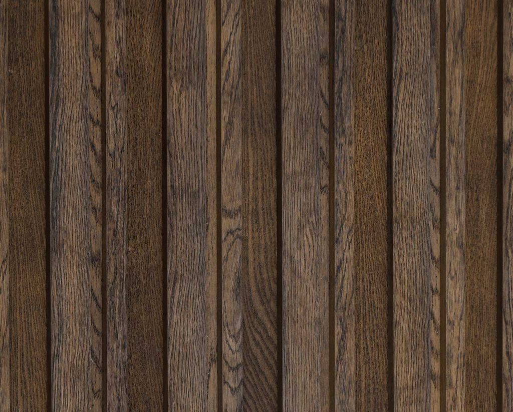 Vertical wood paneling in dark antique oak finish. Detailed wood grain texture.