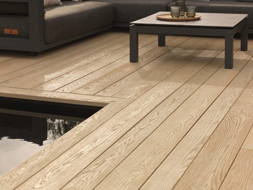 Millboard Antique Oak Decking with a modern outdoor seating area and water feature.