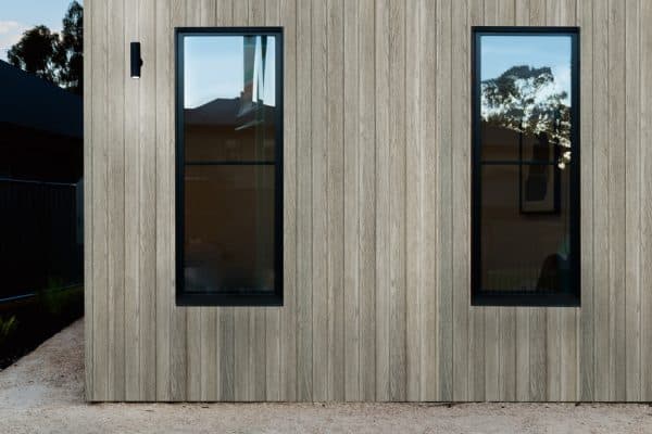 Enhance Your Home's Appeal With Wall Cladding Solutions 2 Concept Materials Composite Decking Modern home exterior with wood wall cladding and black-framed windows, showcasing wall cladding solutions.