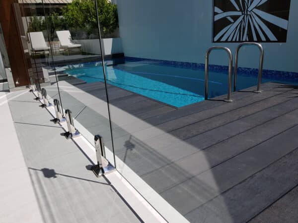 Modern backyard pool area featuring a stylish millboard premium decking.