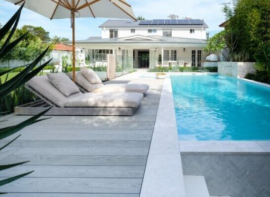 Modern poolside area with millboard smoked oak decking.