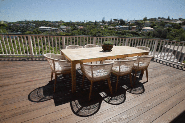 Modern composite deck installation with outdoor dining set. Perfect for luxury outdoor living.
