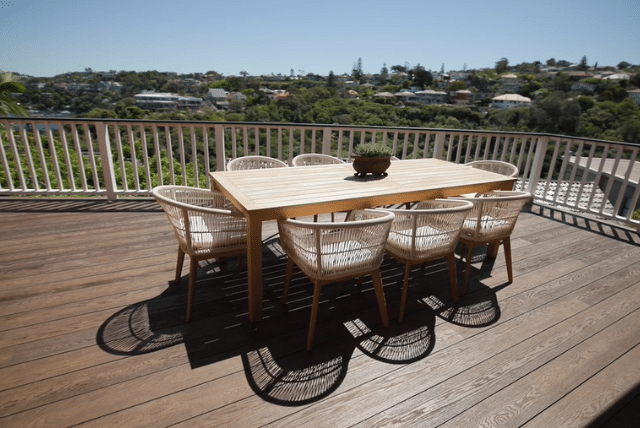 Modern composite deck installation with outdoor dining set. Perfect for luxury outdoor living.