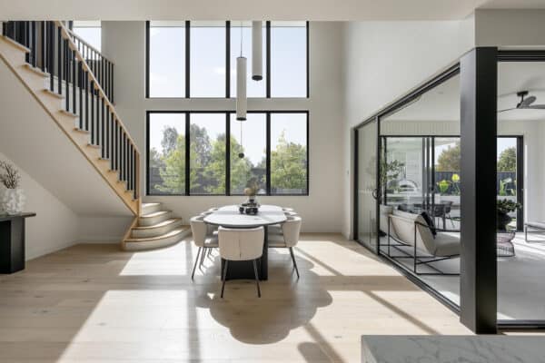 Bright, modern dining area with architectural decking view through large windows.
