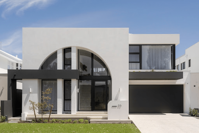 The Arc Display Home: A Benchmark in Modern Home Exterior Design 1 Concept Materials Composite Decking Modern home exterior design with a striking arched entryway and black garage door.