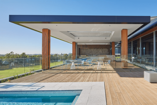 Modern outdoor decking ideas with pool, seating, and view.